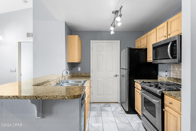 kitchen with light brown cabinets, sink, kitchen peninsula, and stainless steel appliances