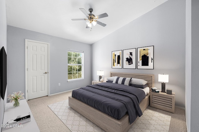 carpeted bedroom with ceiling fan and vaulted ceiling