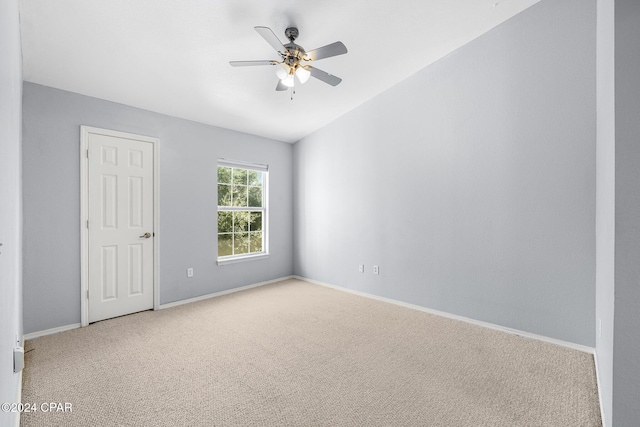 carpeted spare room with ceiling fan