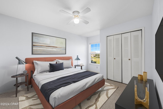 carpeted bedroom featuring a closet and ceiling fan