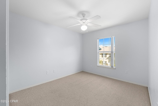 unfurnished room featuring light colored carpet and ceiling fan