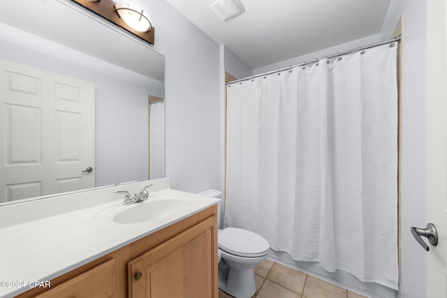 bathroom with tile patterned flooring, a shower with curtain, vanity, and toilet