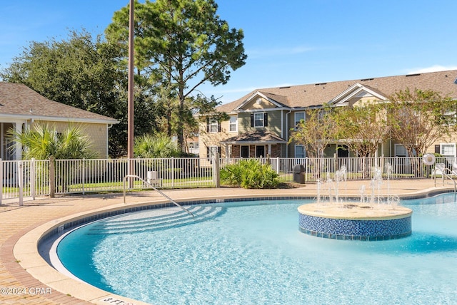 view of swimming pool with pool water feature