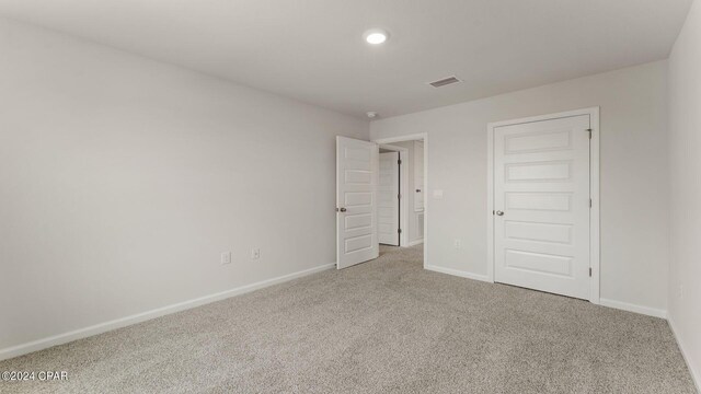 unfurnished bedroom featuring a closet and carpet