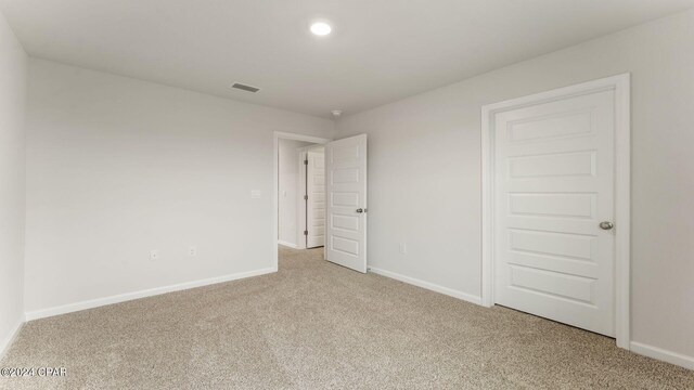 unfurnished bedroom with light colored carpet