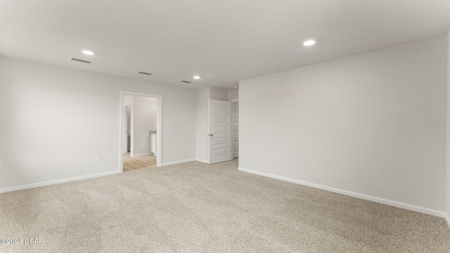 spare room with light carpet