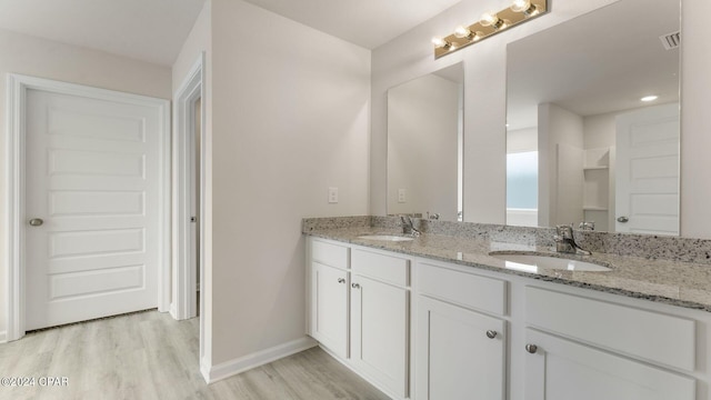 bathroom with vanity and hardwood / wood-style flooring