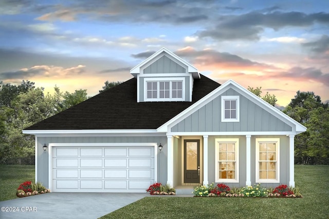 view of front facade with a yard and a garage