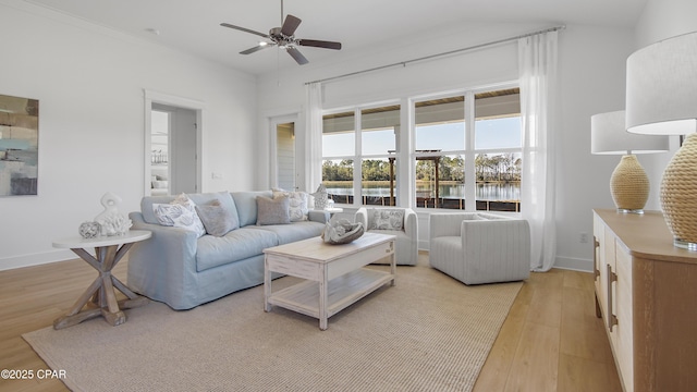 926 Crystal Bayou Blvd, Panama City Beach, FL 32407 - living room with light wood-style flooring, baseboards, a water view, and ceiling fan