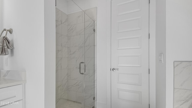 bathroom with vanity and a shower with shower door