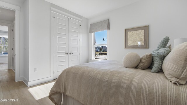 bedroom featuring a closet and light wood-type flooring