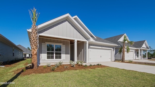 view of front of house with a front lawn, a garage, board and batten siding, and driveway