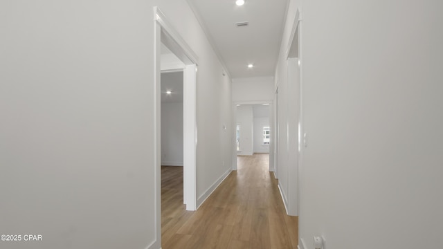 corridor featuring recessed lighting, light wood-style floors, visible vents, and baseboards