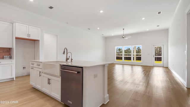 kitchen featuring white cabinets, stainless steel dishwasher, ceiling fan, and an island with sink