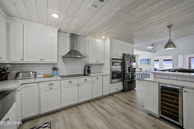 kitchen with white cabinets, stainless steel appliances, wine cooler, and wall chimney exhaust hood