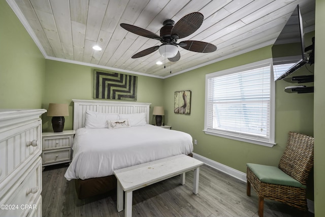 bedroom with ceiling fan, wood-type flooring, crown molding, and wooden ceiling