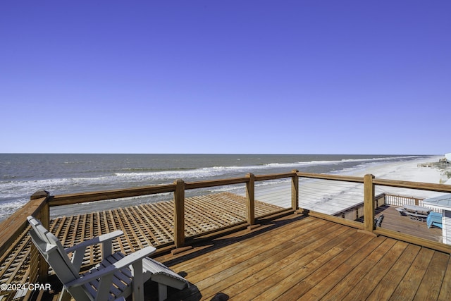 deck featuring a water view and a view of the beach