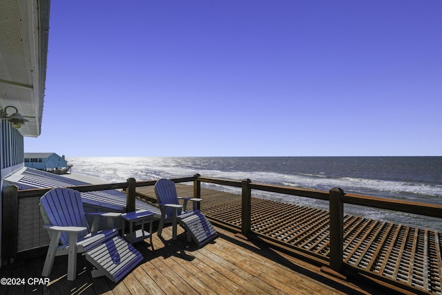 deck featuring a beach view and a water view