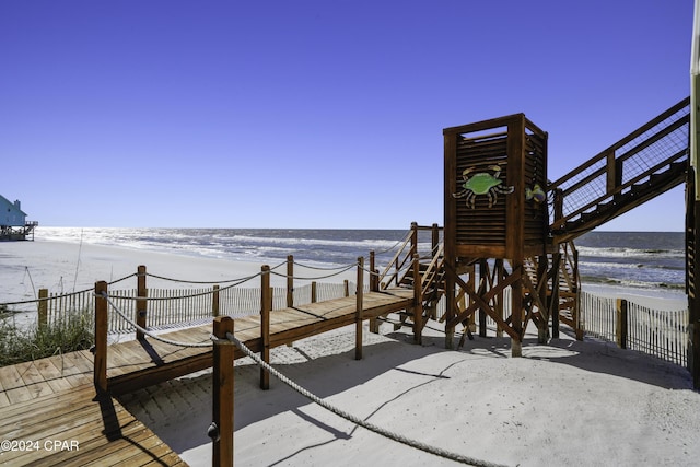 exterior space featuring a water view and a beach view