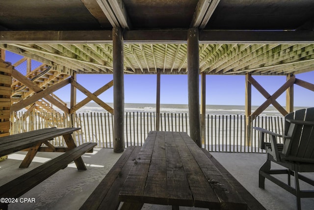 deck with a view of the beach and a water view