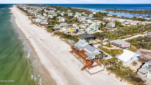 aerial view featuring a view of the beach and a water view