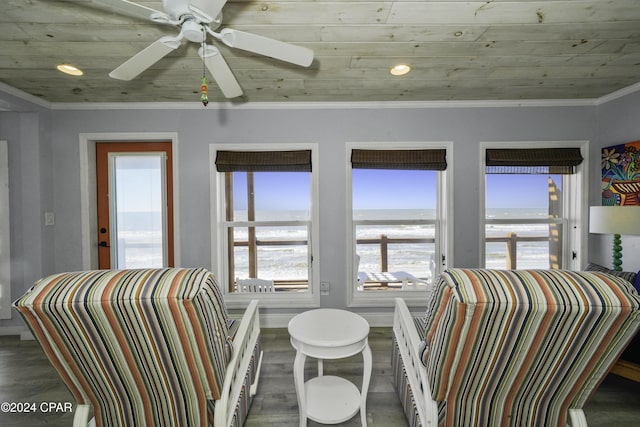 interior space with ceiling fan, dark hardwood / wood-style flooring, wooden ceiling, and ornamental molding