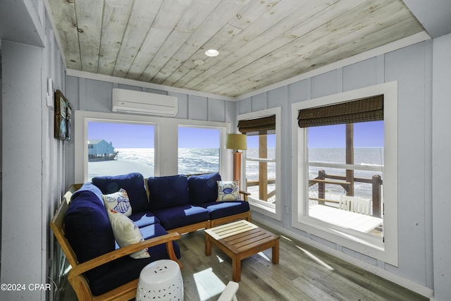 sunroom featuring a wall mounted air conditioner, a water view, and wood ceiling