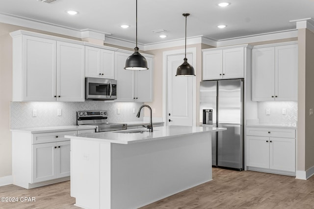 kitchen featuring decorative backsplash, pendant lighting, stainless steel appliances, and sink