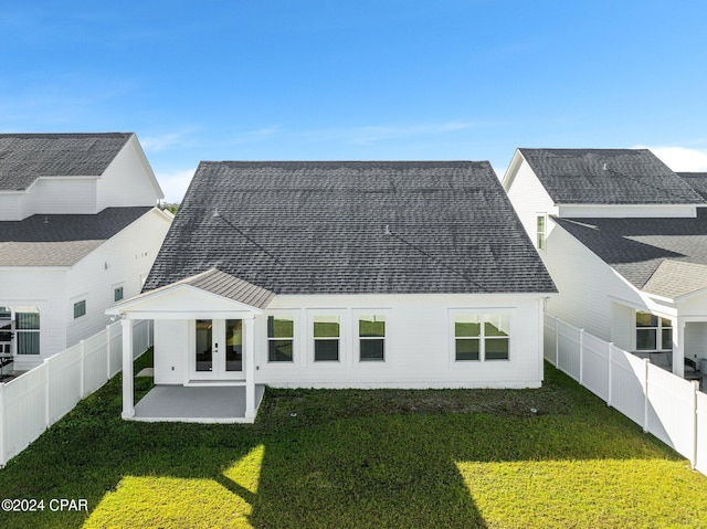 back of property with a lawn and a patio area