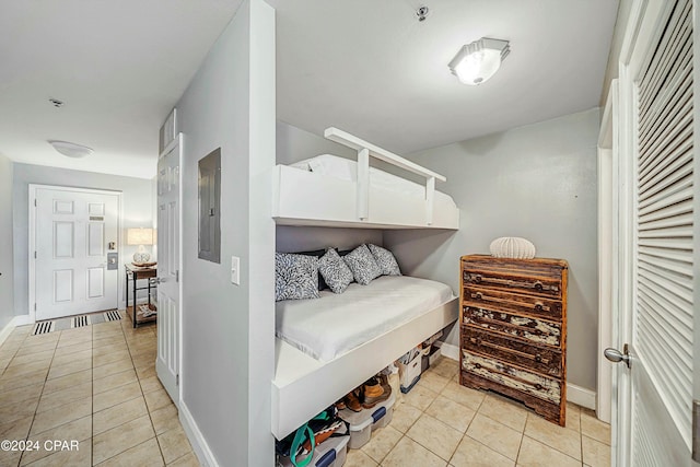 tiled bedroom featuring electric panel