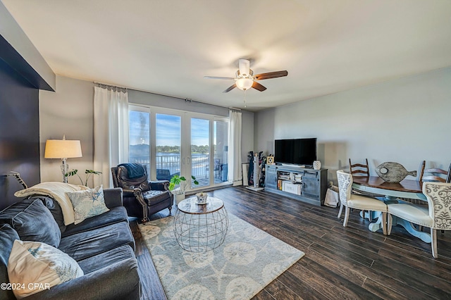 living room with french doors, ceiling fan, and dark wood-type flooring