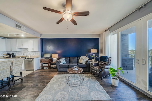 living room with ceiling fan, sink, track lighting, and dark hardwood / wood-style floors