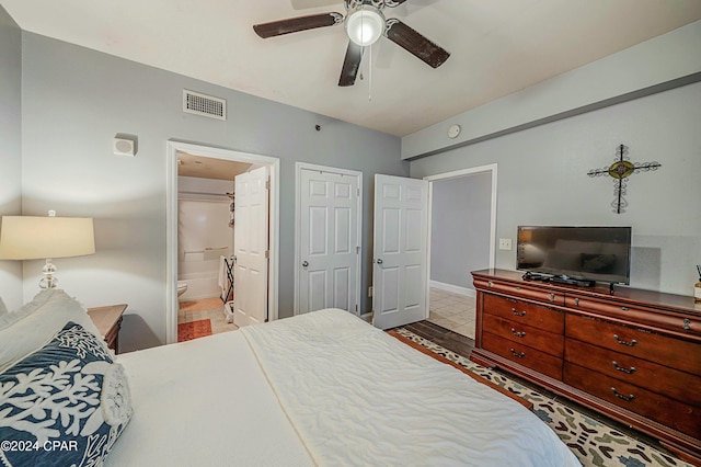 bedroom with ensuite bathroom, ceiling fan, and light hardwood / wood-style floors