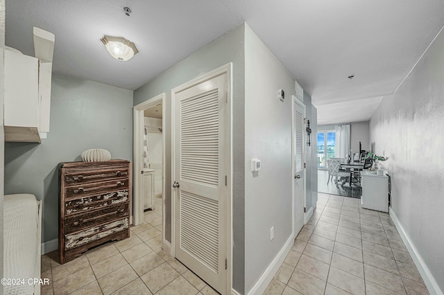 corridor featuring light tile patterned floors