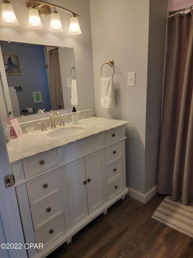 bathroom featuring wood-type flooring and vanity