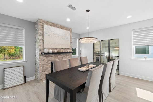 dining room featuring light wood-type flooring and a chandelier