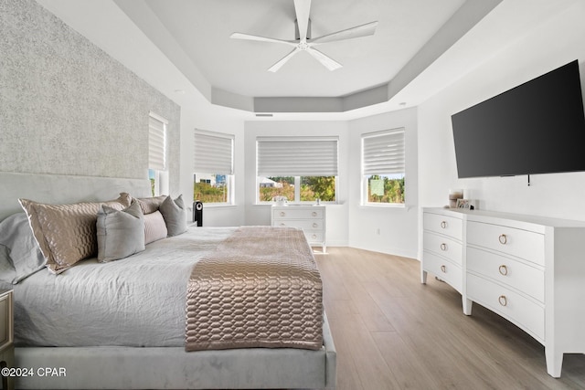 bedroom with ceiling fan and light hardwood / wood-style flooring