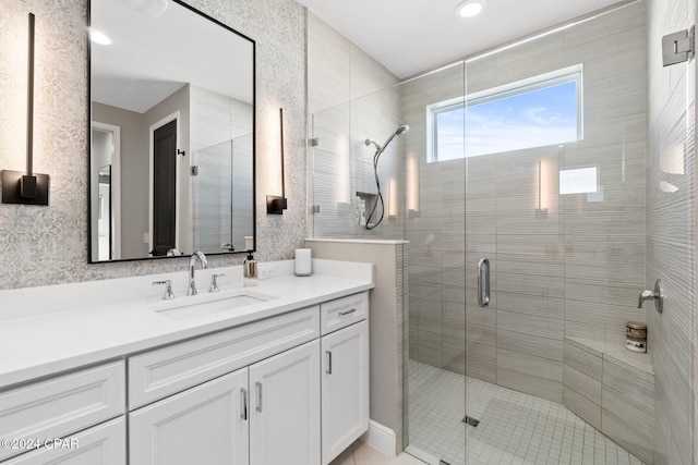 bathroom with vanity and a shower with shower door