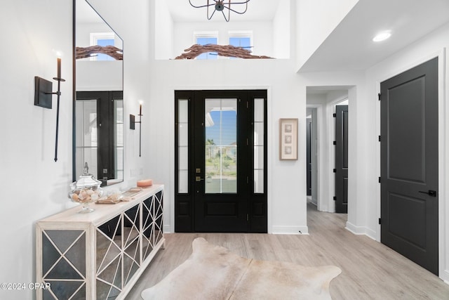 entrance foyer featuring light hardwood / wood-style floors and an inviting chandelier