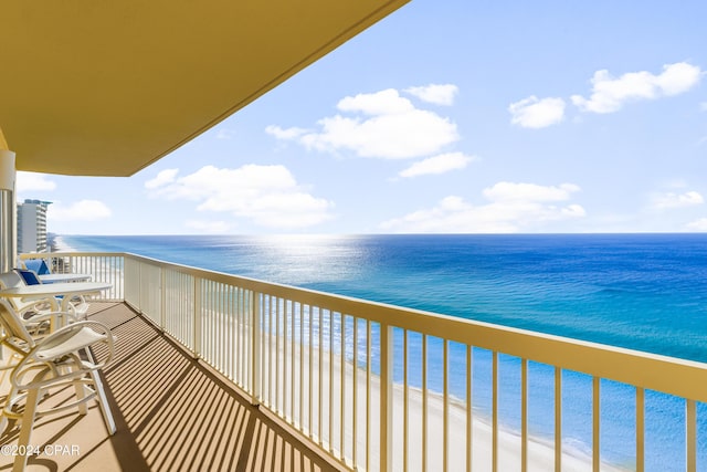 balcony with a view of the beach and a water view