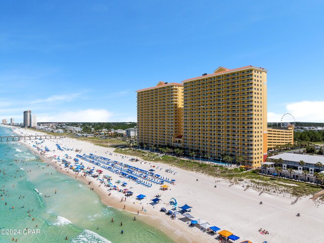 birds eye view of property featuring a water view and a beach view