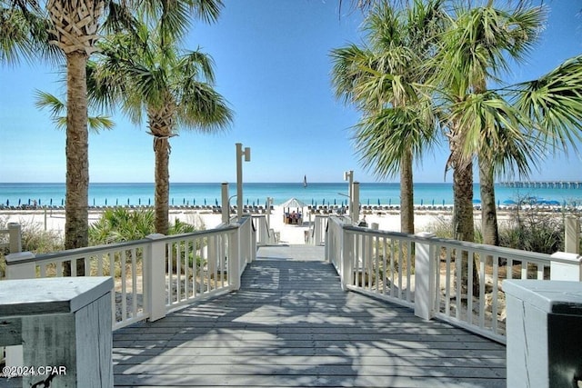 view of community featuring a beach view and a water view