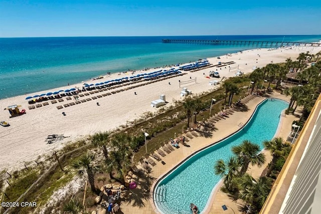 drone / aerial view featuring a water view and a view of the beach