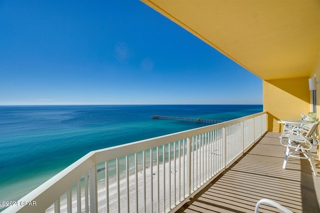 balcony with a water view and a beach view