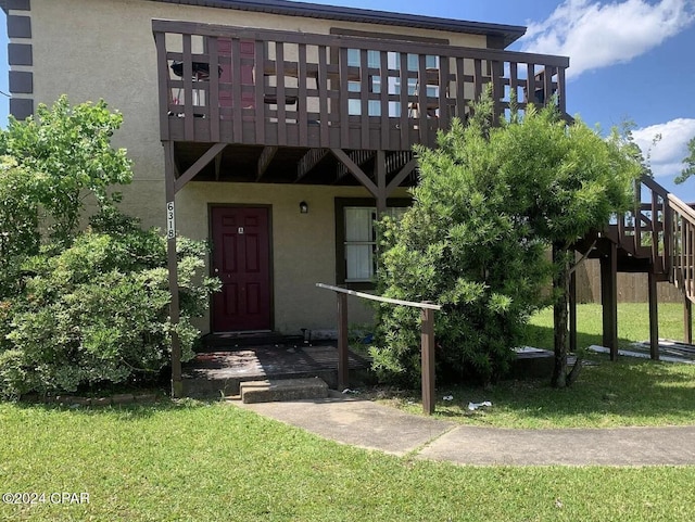 doorway to property featuring a yard