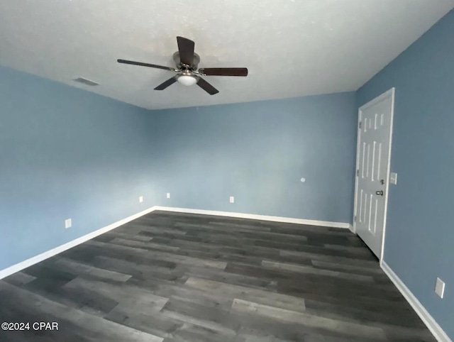 unfurnished room with ceiling fan and dark wood-type flooring