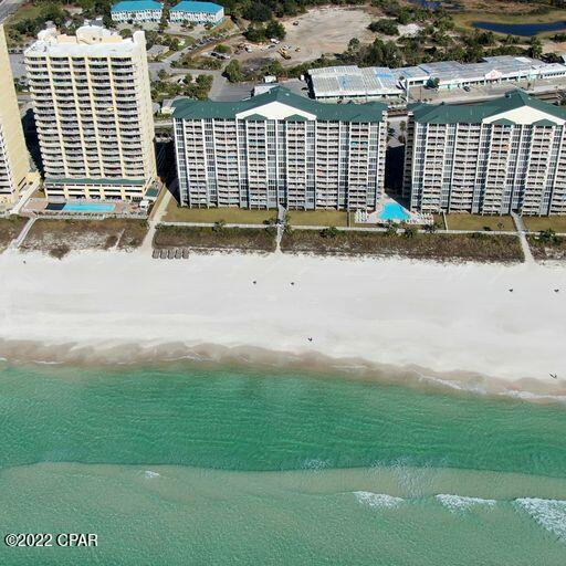 birds eye view of property with a view of the beach and a water view