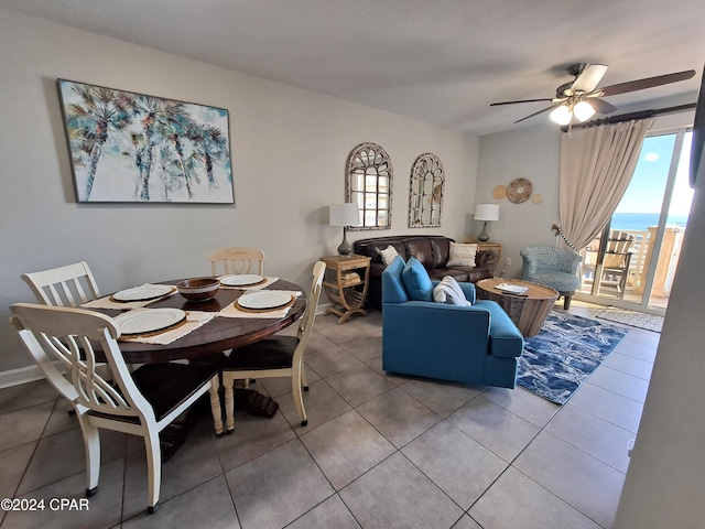 dining space with tile patterned flooring and ceiling fan