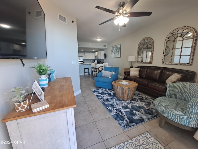 living room with tile patterned floors and ceiling fan