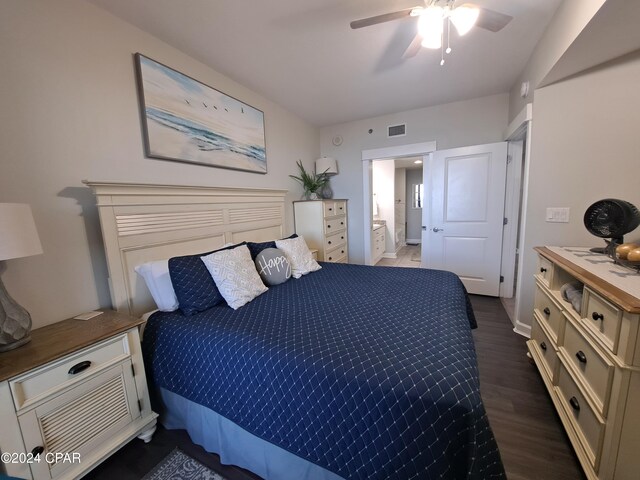 bedroom featuring ceiling fan, dark wood-type flooring, and connected bathroom